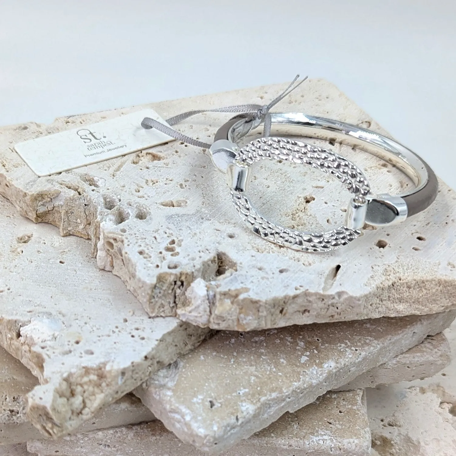 Leather inlay bangle with textured oval component